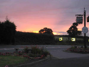 Sunset over the hedges, with lights on below