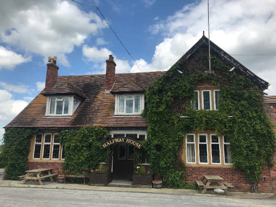 The Halfway House Inn next door, its brick front covered in creeper